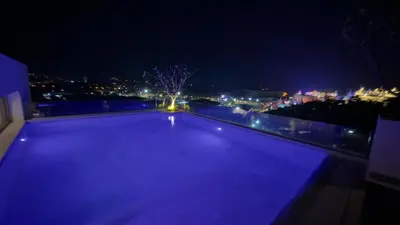 an empty swimming pool at night with a city at New apartment at Fantasea Kamala by Lofty in Kamala Beach