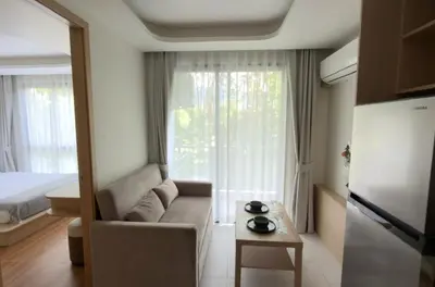 a living room with a couch in front of a window at New apartment at Fantasea Kamala by Lofty in Kamala Beach