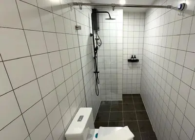 a white tiled bathroom with a toilet and a shower at New apartment at Fantasea Kamala by Lofty in Kamala Beach