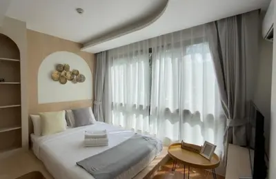 a bedroom with a bed and a large window at New apartment at Fantasea Kamala by Lofty in Kamala Beach