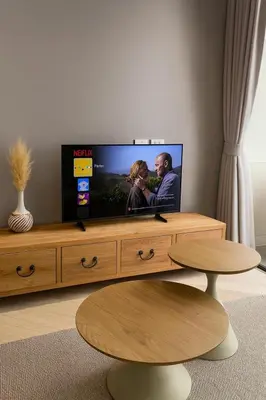 a flat screen tv sitting on top of a wooden entertainment center at Apartment at the brand new Title Legendary by Lofty in Bang Tao Beach
