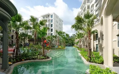 a resort canal with palm trees and buildings at Apartment at the brand new Title Legendary by Lofty in Bang Tao Beach