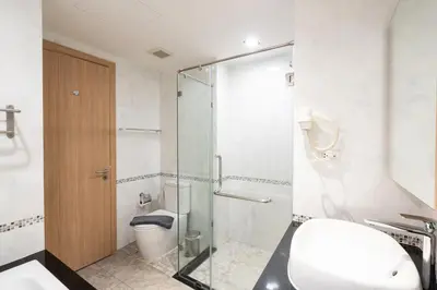 a bathroom with a glass shower stall and a toilet at Modern Studio @ Kata Beach in Ban Karon