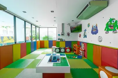a brightly colored room with a table and chairs at Modern Studio @ Kata Beach in Ban Karon