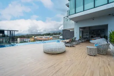 a balcony with chairs and tables on a building at Modern Studio @ Kata Beach in Ban Karon