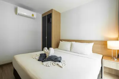 a hotel room with a bed with a towel on it at Modern Studio @ Kata Beach in Ban Karon