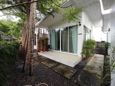a white house with a porch with glass windows at SARANFAT 1 bedroom houses in Ban Thalat Choeng Thale