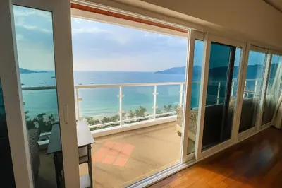 a large balcony with a view of the ocean at Patong Beachfront Tower 30 Floor Penthouse in Patong Beach