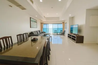 a living room with a couch and a television at Patong Beachfront Tower 30 Floor Penthouse in Patong Beach