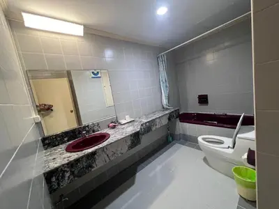 a bathroom with a red sink and a toilet at Patong Beachfront Tower 30 Floor Penthouse in Patong Beach