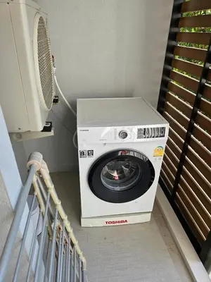 a washing machine in a room with a fan at Comfortable Relax at Rawai Title in Ban Saiyuan (1)
