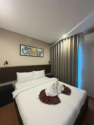 a hotel room with a bed with a towel on it at Comfortable Relax at Rawai Title in Ban Saiyuan (1)