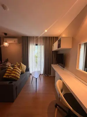 a living room with a couch and a table at Comfortable Relax at Rawai Title in Ban Saiyuan (1)