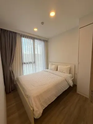 a bedroom with a bed and a large window at Laguna SkyPark in Laguna Phuket