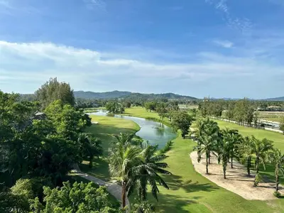 an aerial view of a golf course with a river and palm trees at Laguna SkyPark in Laguna Phuket