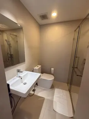 a bathroom with a sink and a toilet and a mirror at Laguna SkyPark in Laguna Phuket