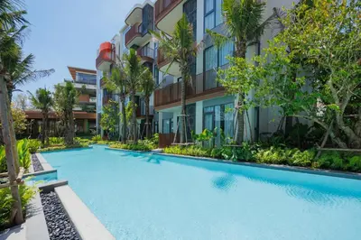 a swimming pool in front of a building at Suite Eden 1BRGarden PoolCanvas Bang Tao Beach in Laguna Phuket