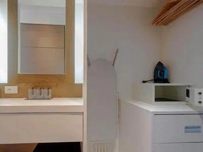 a kitchen with white cabinets and a sink at Blue Sky Penthouse @ Kamala Beach in Kamala Beach