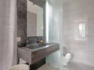 a bathroom with a sink and a toilet at Blue Sky Penthouse @ Kamala Beach in Kamala Beach