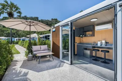 an open kitchen and living area of a tiny house at Apple House Phuket with cozy terrace Pool & beach in Ban Lum Fuang