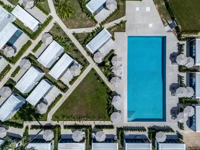 an overhead view of a pool at a resort at Apple House Phuket with cozy terrace Pool & beach in Ban Lum Fuang