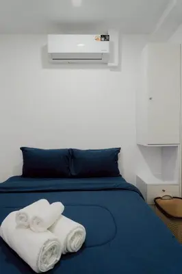a bed with two white towels sitting on it at 3Bedrooms Mountain View at Patong Tower Phuket in Patong Beach