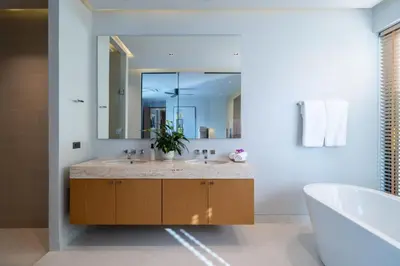a bathroom with two sinks and a large mirror at Villa Kaya, 3BR contemporary pool villa in Phuket