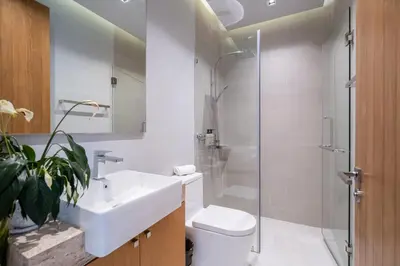 a bathroom with a toilet and a sink and a shower at Villa Kaya, 3BR contemporary pool villa in Phuket