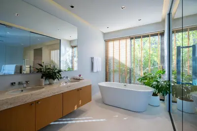 a bathroom with a large tub and a large window at Villa Kaya, 3BR contemporary pool villa in Phuket