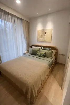 a bedroom with a large bed and a large window at New 1BR Condo, walk to Bang Tao Beach in Laguna Phuket