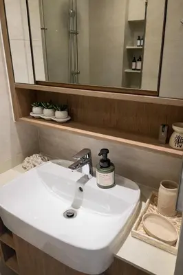 a bathroom with a white sink and a mirror at New 1BR Condo, walk to Bang Tao Beach in Laguna Phuket