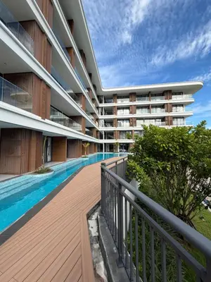 an external view of a building with a swimming pool at Beach Resort along coastline of Layan beach in Layan Beach