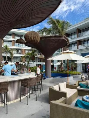 a resort patio with chairs and tables and umbrellas at Beach Resort along coastline of Layan beach in Layan Beach