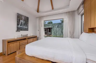 a bedroom with a large bed and a window at Modern 3BR Villa Kaimana with Private Pool in Ban Phru Champa
