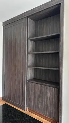 a wooden wall with shelves in a room at Apartments with access to Rama IX Park in Ban Lo Long