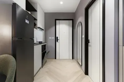 a kitchen with a black refrigerator and a hallway at Studio with a terrace in The Title Legendary in Bang Tao Beach