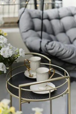 a coffee table with two cups and plates on it at Studio with a terrace in The Title Legendary in Bang Tao Beach