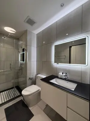 a bathroom with a toilet and a sink and a mirror at Title Legendary 2 bedroom in Bang Tao Beach