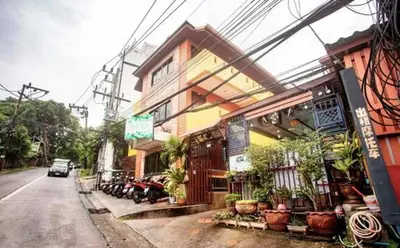 a car driving down a street next to a building at For 3 Person in Central Pa Tong, Thailand in Patong Beach