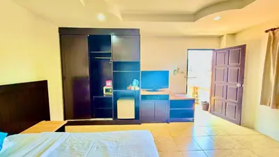 a bedroom with blue cabinets and a bed and a door at For 3 Person in Central Pa Tong, Thailand in Patong Beach
