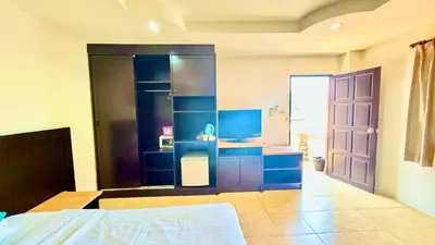 a room with a bed and a kitchen with blue cabinets at For 3 Person in Central Pa Tong, Thailand in Patong Beach