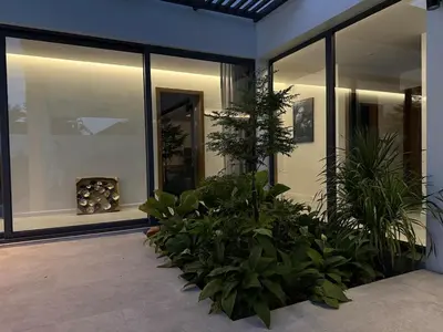 a house with a bunch of plants in a courtyard at Newly built private Quinta Lane 4br pool villa in Ban Saiyuan (1)
