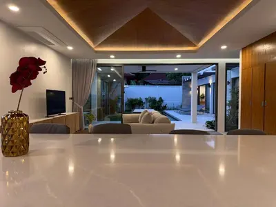 a living room with a large white table and a couch at Newly built private Quinta Lane 4br pool villa in Ban Saiyuan (1)