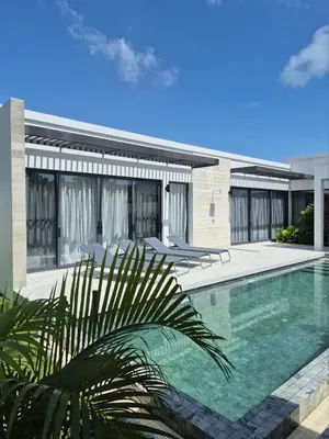 a swimming pool in front of a house at Newly built private Quinta Lane 4br pool villa in Ban Saiyuan (1)