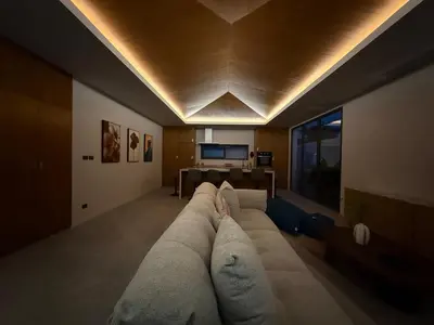 a living room with a large couch and a table at Newly built private Quinta Lane 4br pool villa in Ban Saiyuan (1)