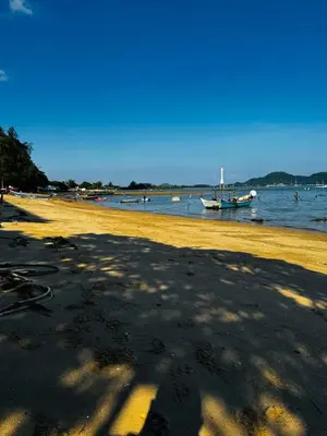 a beach with a boat in the water at Villa Mayfair 4 bedrooms sea view with pool table in Ban Bang Chak
