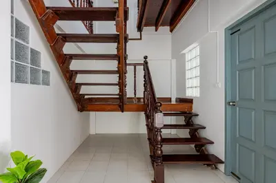 a wooden staircase in a room with a green door at Villa Mayfair 4 bedrooms sea view with pool table in Ban Bang Chak