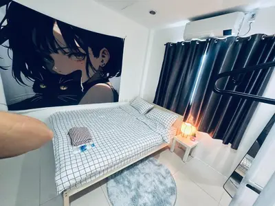 a room with a bed with a picture of a cat at HulaFling Homestay in Ban Bo Han