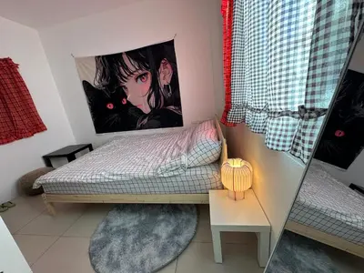 a bedroom with a bed with a painting on the wall at HulaFling Homestay in Ban Bo Han
