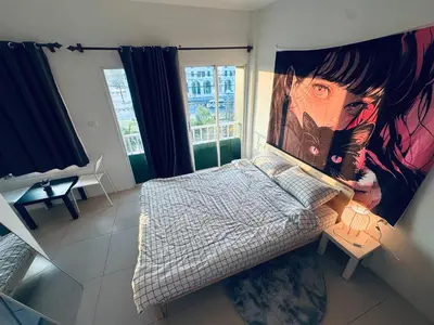 a bedroom with a large painting on the wall at HulaFling Homestay in Ban Bo Han